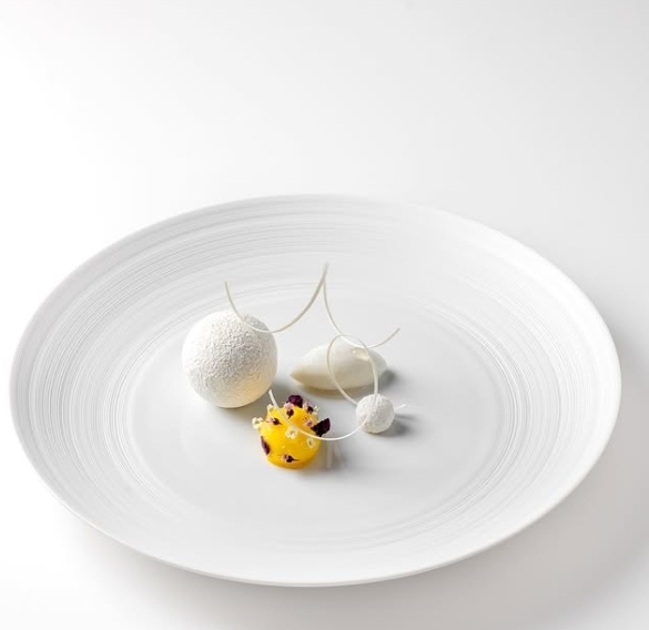 Plated dessert with sugar arc